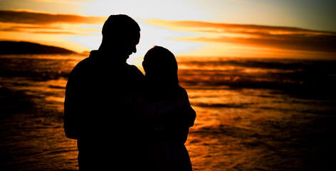 Sticker - Couple, silhouette and hug on beach with love, bonding and romance date for tropical travel for marriage. Smile, woman and man with embrace shadow of relationship, sunset and loyalty of ocean outdoor