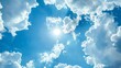 © Dasha Yurk - Blue sky background with clouds and sunlight. AI generation