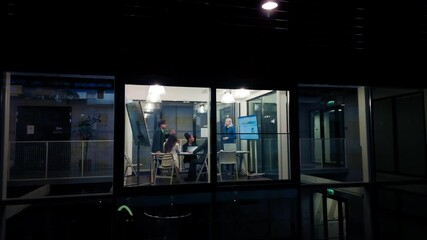 Poster - Group of Corporate Workers Analyzing Results From a Marketing Campaign. Project Manager Presenting Data Chart on Screen, Employees Having a Conversation in a Meeting Room. View from Outside the Window