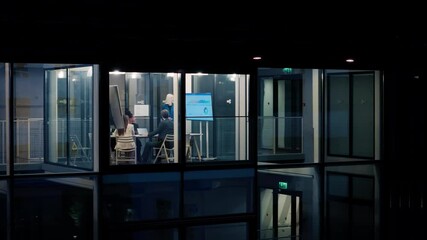 Poster - Female Manager Making a Presentation to a Board of Directors in a Meeting Room Late in the Evening. Young Executive Using a Digital Interactive Whiteboard. Night View From Out of the Window