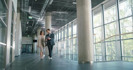 Poster - Corporate Colleagues Walking to a Meeting in an Office. Male Assistant Showing Information on a Tablet Computer to a Female Executive. Team of Managers on Their Way to a Business Meeting with Partners