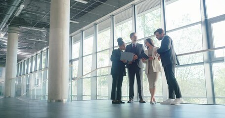 Poster - Team of Managers and Employees Having an Urgent Meeting Right in the Hallway. Diverse Male and Female Specialists Inspecting Online Business Data on Computers, Discussing Results of a Report
