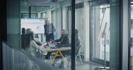 Aufkleber - Group of Corporate Workers Analyzing Results From a Marketing Campaign. Project Manager Presenting Data Chart on Screen, Employees Having a Conversation in a Meeting Area. View From Outside the Room