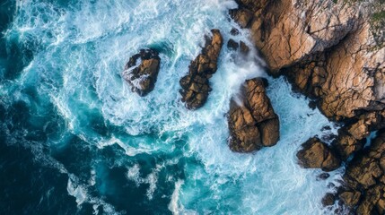 Aerial View of Waves Crashing Against Rugged Coastline.