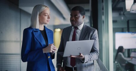 Aufkleber - Black Male CEO and a Project Manager Standing in a Modern Office in Downtown Area. African Man and Caucasian Women Setting Up Business Meetings On a Laptop Computer, Checking Financial Reports
