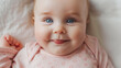 © Mutshino_Artwork - Portrait of a Smiling Baby with Big Blue Eyes on a Soft White Blanket