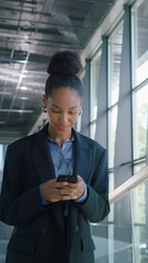 Poster - Vertical Screen: African Female Professional Walking Through an Office Hall, Using Her Smartphone for Browsing Online. Young Woman Connected to the News, Social Network Data and Internet Applications