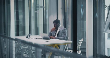Aufkleber - African Manager Focused on Work in a Modern Glass Walled Meeting Room. Company Owner Diligently Using Laptop Computer. Productive Black Male is Dealing with Business Tasks in a Contemporary Workspace