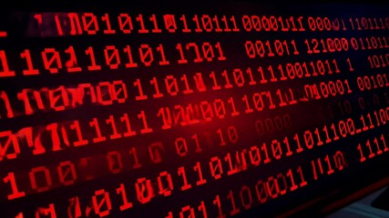 Binary code streams in red on a dark background, showcasing the dynamic flow of digital information in a technological setting.