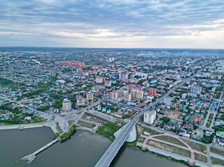 A road bridge over the Tobol River and a view of the city.