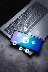 smartphone laying on laptop displaying protection holographic interface. cyber security. security an