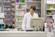© ArcursForPI/peopleimages.com - Pharmacy, computer and stock list with woman at counter in drugstore for customer service, advice and medicine. Prescription drugs, pharmacist and inventory for pills, medication and chemist checkout