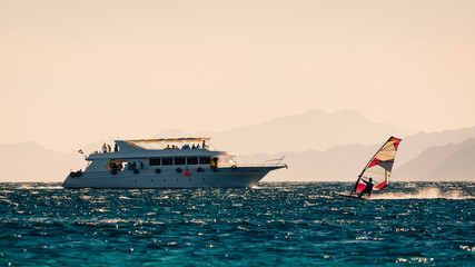 Poster - big boat and windsurfer on the background of high mountains in Egypt Dahab South Sinai