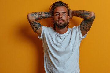 Confident tattooed man posing against bright orange background