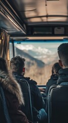 A group of passengers gazes out the bus windows, enjoying the breathtaking mountain scenery on a clear day