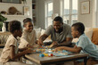© MobiWall - An engaging family game night in the living room. The family is gathered around a coffee table, playing board games. They are laughing, cheering, and enjoying each other's company. cozy room