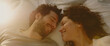 © Elena - Couple in love waking up together in bed, overhead view