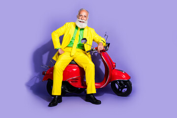 Poster - Photo of funny senior nice man wearing yellow stylish clothes sitting motorcycle isolated on purple color background