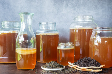 Wall Mural - various types of Oolong tea leaves with jars of kombucha and scoby