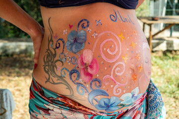 Beautiful painting of multi-colored pregnant mother belly