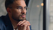 © Yuliia - Arabian Indian man thoughtful pensive serious business guy male thinking puzzled businessman office think ponder idea question problem solution decide consider dream doubt close up portrait indoors