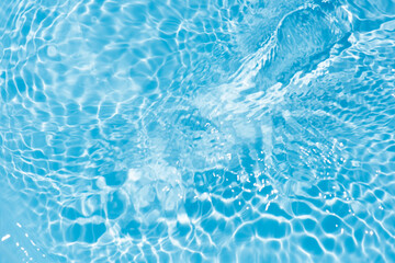 Sticker - Blue water with ripples on the surface. Defocus blurred transparent blue colored clear calm water surface texture with splashes and bubbles. Water waves with shining pattern texture background.