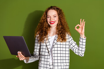 Canvas Print - Photo portrait of pretty young girl netbook show okey approve wear trendy white plaid outfit isolated on khaki color background