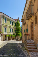 Poster - A street between old houses in Carovilli, a village in Molise in Italy.