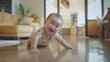 © VK Studio - A smiling baby boy crawls energetically on a polished wooden floor in a modern living room, surrounded by bright daylight.