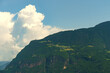 © Dzmitry - A Majestic Mountain Range Basking Under a Fluffy Cumulus Cloud in a Sunny Summer Sky