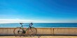 © Collection - Road bicycle parked against a wall by the seaside with a clear blue sky backdrop, road bicycle, wall, seaside