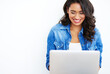 © peopleimages.com - Laptop, space or happy woman typing for blogging or internet to search for streaming mockup in studio, White background, girl or blogger on technology for editing, posting or social media news