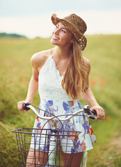 Canvas Print - Thinking, bicycle or happy woman cycling in field for holiday, adventure or wellness to relax in nature. Smile, healthy or confident girl on bike for eco friendly travel, carbon footprint or vacation