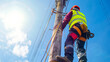© Jafree - Worker in protective gear climbing up an electric pole with a clear blue sky in the background. The concept of electrical maintenance, safety, and utility services