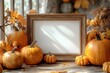 © Zaleman - Decoration orange small smile Halloween pumpkin mockup template with white frame and wooden borders on an orange blurred background and copy space. It's a holiday autumn concept mockup template.