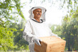 © Ljupco Smokovski - Male bee keeper holding a wooden box
