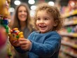 © Natpasit - A happy child excitedly picks out toys in a store, with their mother smiling in the background, capturing a moment of joyful bonding..