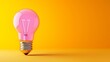 © Nataliia_Trushchenko - A light bulb is lit up and is sitting on a yellow background. Concept of creativity and inspiration, as the light bulb is often associated with ideas and innovation