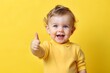 © Meera Graphic  - baby giving a thumbs up on yellow background