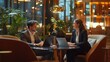 © Sasa Visual - Two Caucasian business individuals are discussing ideas over laptops in a stylish office environment with greenery