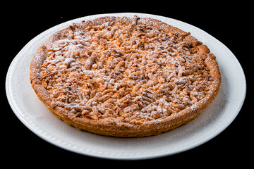 Wall Mural - Crumbly pie with chocolate and powdered sugar in a plate.