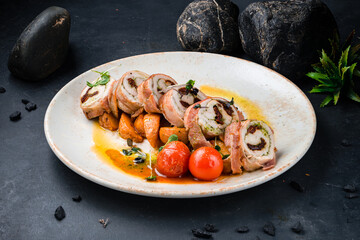 Canvas Print - Chicken rolls in bacon with pesto sauce and sun-dried tomatoes in a plate.