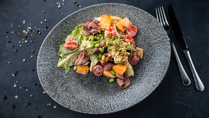 Wall Mural - Fresh meat salad with beef slices, beans, lettuce, cherry tomatoes, pumpkin and seeds.