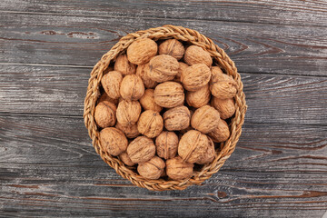 Sticker - walnuts basket on wood background top view