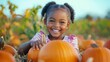 © JW Studio - Happy adorable toddler black girl enjoy harvest in autumn pumpkin patch ranch field, funny joyful baby portrait in fall season sunset picking orange pumpkins, Thanksgiving Halloween child backgrounds