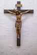 © Bernhard - The historic wooden crucifix on a white wall.