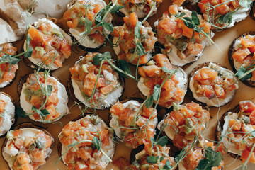 Rye bread open sandwiches with salted salmon, cream cheese and green, top view, flat lay