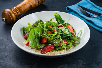 Poster - Fresh green salad with strawberries, spinach, arugula, spices, sauce and sesame seeds.