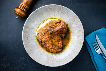 Poster - Fried pork fillet steak with baked cabbage and sauce.