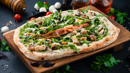 Italian lunch pinza or pizza with crayfish, squid, mussels, arugula, cheese and sauce.